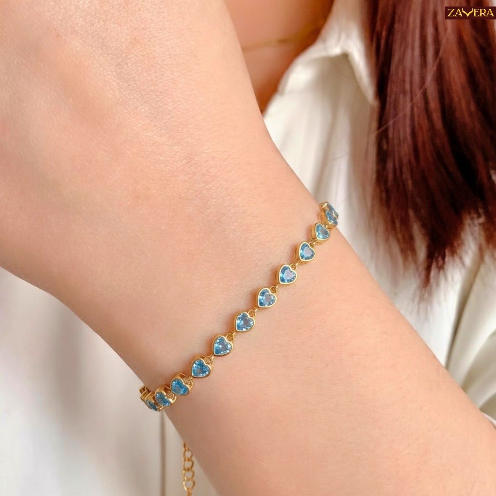 Zavera Gold Plated Blue Heart American Diamond Bracelet for Women